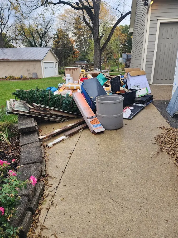 Dumpster being loaded with debris for Demolition Dumpster Rental in Grandville